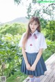 A woman in a school uniform posing for a picture.