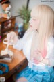 A woman sitting at a table eating a piece of cake.