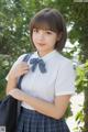 A young woman in a school uniform posing for a picture.