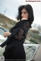 A woman in a black dress posing for a picture.