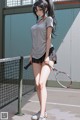 A woman holding a tennis racket on a tennis court.